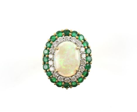 Opal emerald and diamond cocktail ring, with a central oval cabochon cut opal, measuring 13.59 x 10.15 x 3.03mm, weighing a c