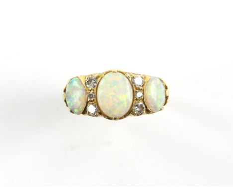 Vintage opal and diamond ring, the centre opal is a synthetic, the side stones are natural, set with six diamonds in total, e