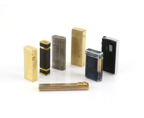 A collection of seven lighters, including Dunhill Tallboy Cartier Licence, in a gilt metal case with black leather surround m