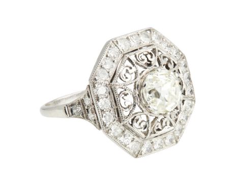 A diamond cluster ringclaw set with an old cut diamond within a border of filigree scrolls and an outer octagonal border pavé