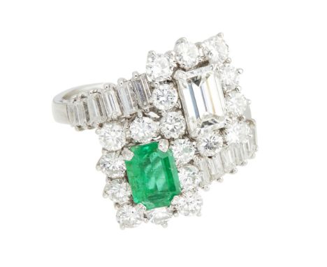 An emerald and diamond set ringclaw set with an emerald cut diamond and emerald, in a border of round brilliant cut diamonds,