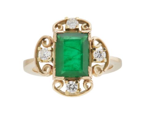 An emerald and diamond ringclaw set with a rectangular mixed cut emerald within a scrolling wirework surround, further claw s