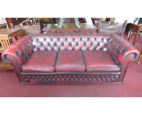 A three seater red leather Chesterfield sofa by 'Winchester furniture' 