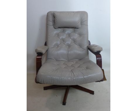 A 20th century swivel chair, with button back leather upholstery on exotic hardwood base, H.101cm 
