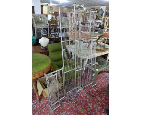A vintage pair of train luggage racks together with a smaller example 