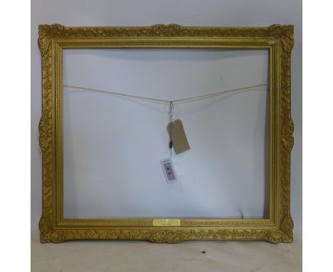 A late 19th/early 20th century gilt wood picture frame, with plaque for R O Dunlop, outer - 79 x 91cm inner - 63 x 77cm 