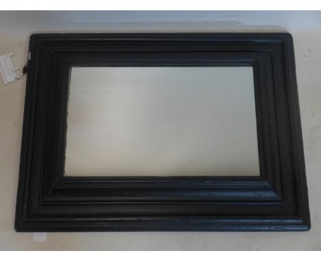 A black painted mirror in thick frame, 80 x 59cm 