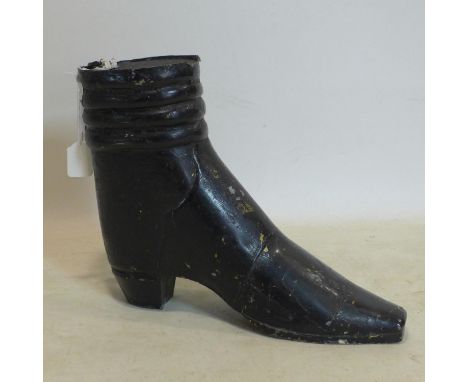 A vintage trade sign in the form of a black metal boot, H.39 W.49 D.14cm 