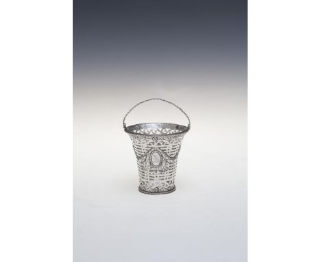 A GEORGE III IRISH SILVER CONDIMENT BASKET, Dublin (marks rubbed), the pierced tapering body decorated with foliate swags and