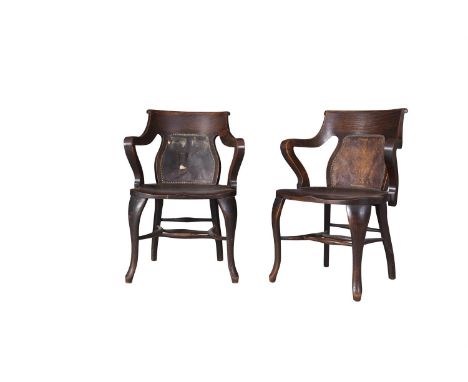 A PAIR OF ART NOUVEAU OAK FRAMED TUB BACK CHAIRS, the shaped backs with studded and leather upholstered panelled seats, raise