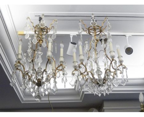 A PAIR OF FRENCH GILT METAL FRAME SIX LIGHT CHANDELIERS, decorated with pendant cut drops in tiers. (2)