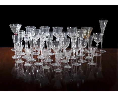 A MISCELLANEOUS COLLECTION OF GLASS, comprising:- candlestick holders- nine glasses- champagne flutes- liqueur glasses etc.