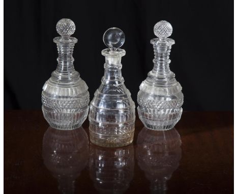 A PAIR OF 19TH CENTURY MALLET SHAPED GLASS DECANTERS AND STOPPERS, with star cut base, the body decorated with reeded and cry