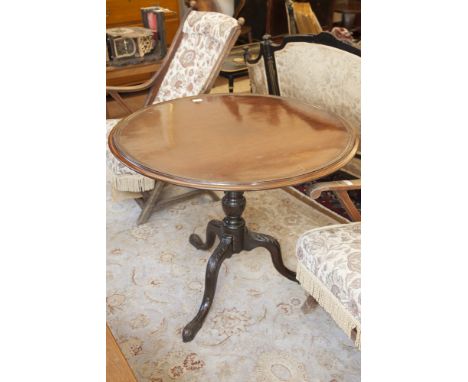 A 19TH CENTURY MAHOGANY CIRCULAR SNAP-TOP SUPPER TABLE with moulded rim and raised on turned  centre pillar and carved tripod