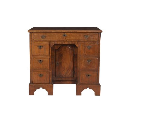 A GEORGIAN INLAID WALNUT AND CROSSBANDED KNEEHOLE WRITING DESK, of rectangular form, with quarter veneered top with feather b