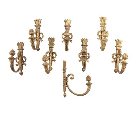 A COLLECTION OF EIGHT FRENCH NATURALISTIC GILT METAL WALL HOOKS, each with feather crested back plate, the ribbon tied out sc
