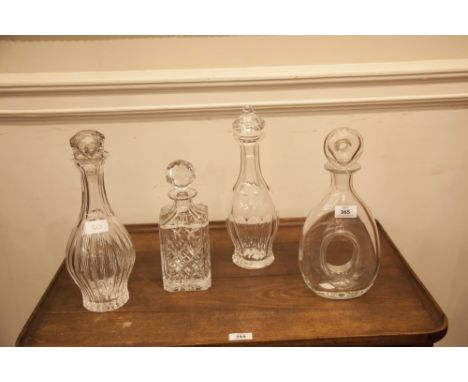 A WATERFORD CRYSTAL CIRCULAR FACET CUT BALUSTER DECANTER AND STOPPER; another decanter of similar design; together with two m