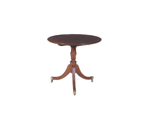 A GEORGE III MAHOGANY CIRCULAR SNAP-TOP SUPPER TABLE with carvetto top raised on ring tunnel centre pillar tripod supports wi