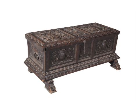 A 17TH CENTURY OAK ARMORIAL CARVED COFFER, of rectangular form, the hinged top boldly carved with oval portrait medallions an