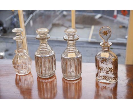A PAIR OF LATE 19TH CENTURY REEDED CYLINDRICAL DECANTERS WITH MUSHROOM STOPPERS; together with another Victorian decanter; an