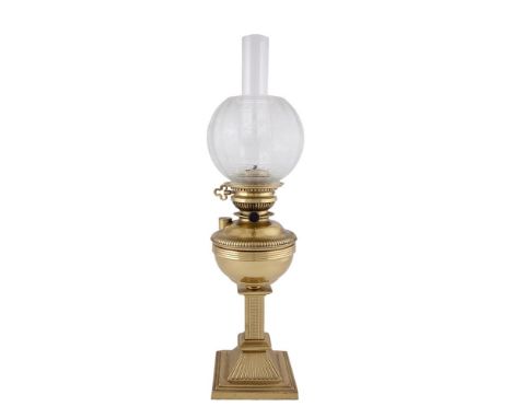 A 19TH CENTURY BRASS OIL LAMP, with circular reservoir decorated with beading and with reeded banding, raised on a square pil