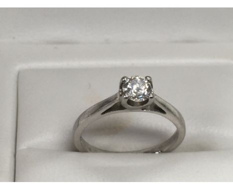 A platinum solitaire diamond ring, approx 0.25ct and approx size M. Comes with gemologist report card.