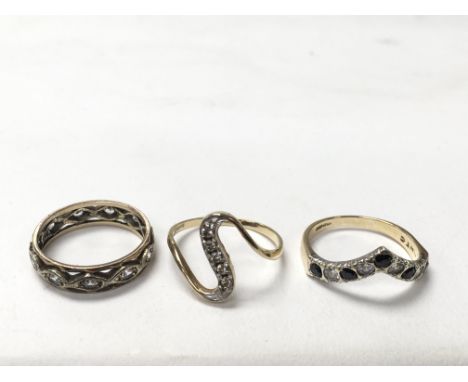 3 9ct gold rings - one is an eternity ring, one a stone set wishbone ring and one as an S shape.