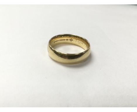 An 18ct gold plain band, measuring in ring size approximately L and weighing approximately 5g.