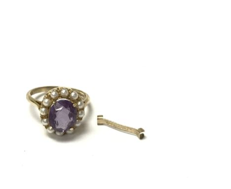 A 9ct gold amethyst and pearl ring, measuring the approximate ring size K. Complete with a 9ct gold ring resizing clip.