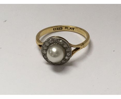 A Art Deco style 18 ct gold ring inset with a central pearl surrounded by diamonds size M