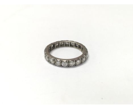 An unmarked white gold eternity ring set with diamonds. The approximate ring size is between M and N.