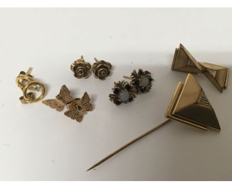 An unmarked Art Deco design stick pin with matching earnings (one damage) and other gold earrings (a lot)