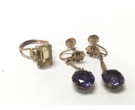 An unmarked gold ring, approximately ring size K , as well as a pair of unmarked gold earrings.