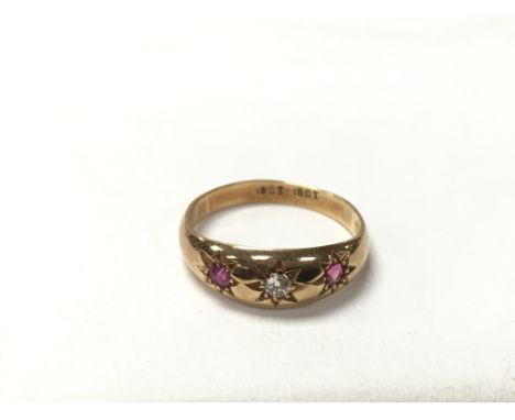 An 18ct gold hallmarked ruby and diamond set ring. The approximate ring size is R.