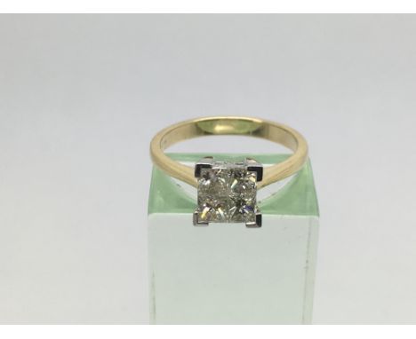 An 18ct yellow and white gold diamond ring set with four invisible set diamonds. Diamonds approx 0.75ct, approx weight 4g and