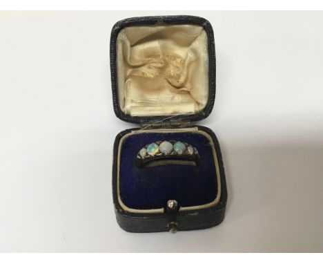 An Antique 18carat gold and Opal ring set with five graduating opals and chip diamonds (one cracked) ring size S.