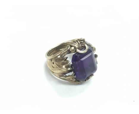 A gents gold ring set with an amethyst, approx 9.2g and approx size K-L.