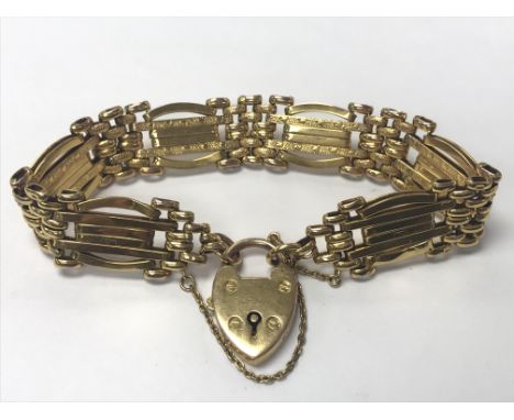 A 9ct gold gate bracelet with a heart shaped padlock clasp. Weighing approximately 16g.