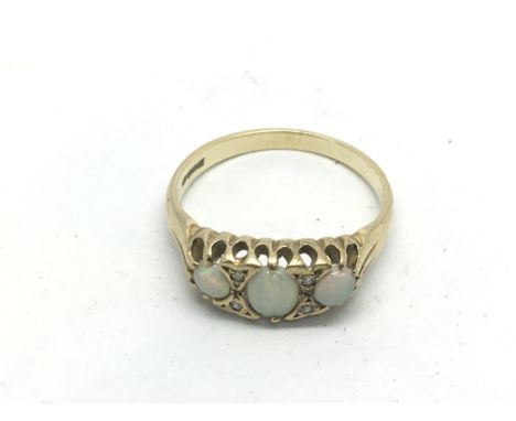 A gold three stone opal ring, approx 2.2g and approx size M.