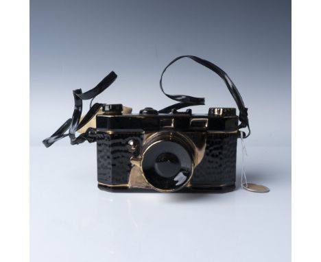 Vintage ceramic figurine designed to resemble a classic film camera with intricate details. This piece features a glossy blac