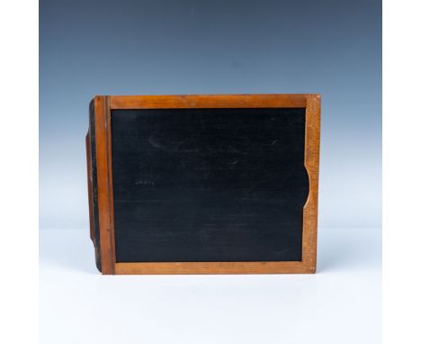 A vintage wooden double-sided plate holder designed for large format cameras, used to securely hold photographic glass plates