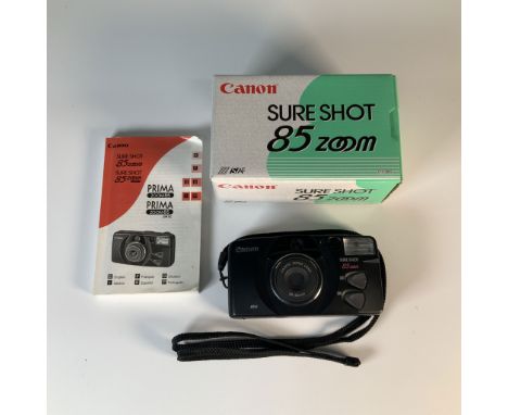 Canon Sure Shot 85 Zoom 35mm film camera featuring a 38-85mm Canon zoom lens, complete with original box and instruction manu