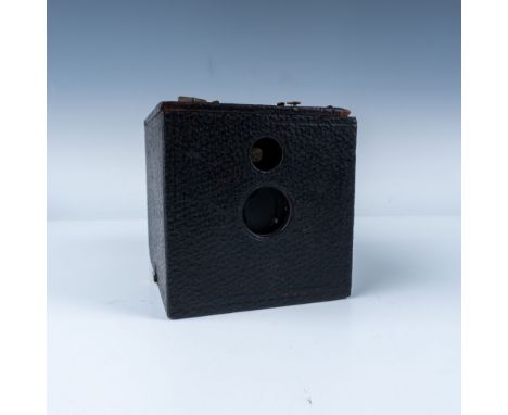 A beautifully crafted wooden box camera produced by Eastman Kodak Co. in the early 1900s. The camera features a wood body cov