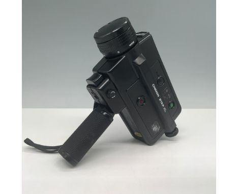 A vintage Chinon 213PXL Super 8 movie camera, complete with its original instruction manual and a Kodachrome 40 Super 8 cartr