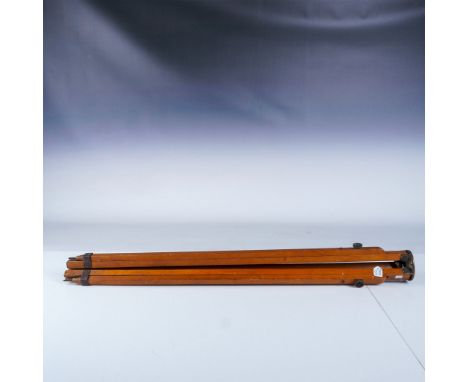 This vintage camera tripod is crafted by the American Optical Company, showcasing a sturdy wooden construction with metal fit