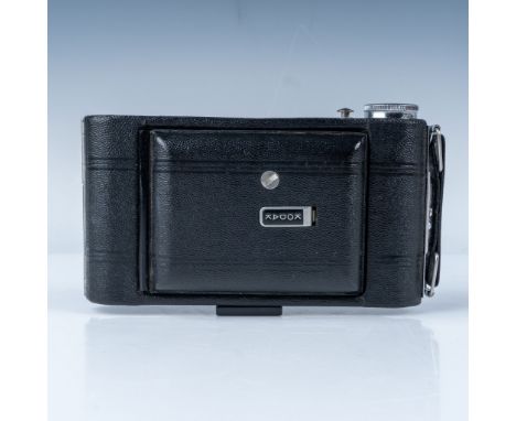 Designed for medium-format photography, the camera features a folding bellows system, a fixed-focus Kodak lens, and a simple 
