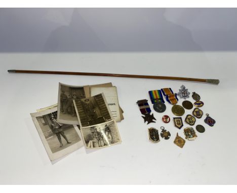 A tray of medals of World War I interest, including a 9ct gold medal, swagger stick, various photographs in uniform and other