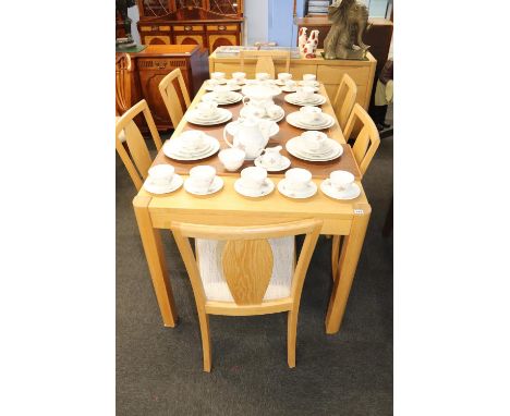 An as new light oak dining room suite