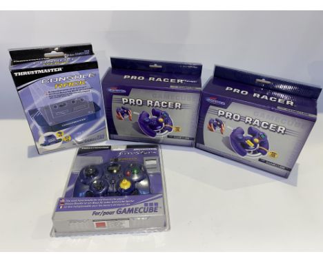 Two boxed Gamester Pro Racer Game Cube controllers, a Gamecube console rack and a Firestorm controller and memory cards