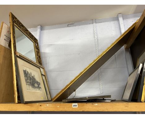A shelf of mirrors and prints